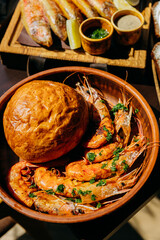 Grilled prawns with freshly baked bread in bowl, ideal for seafood lovers and restaurant menus