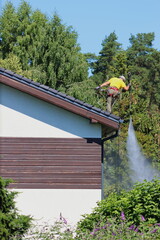 Washing roofs with a pressure washer