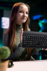 Gen Z content creator presenting keyboard from brand sponsoring video, urging fans to buy it. Young...
