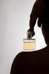 Photo of perfume on a woman's silhouette