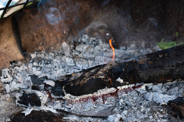 Burning Log with Glowing Embers in a Campfire for publication, poster, screensaver, wallpaper, banner, cover, post. High quality photography