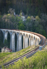 Train tracks on an old arched bridge