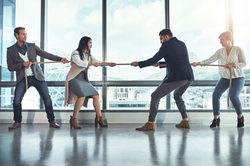 Tug of war, business and people in office for battle, rivalry and healthy competition for growth. Team building, men and women in corporate workplace with rope, pull and challenge for staff in city