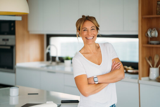 Confident blonde woman in kitchen