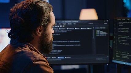 Computer engineer deliberating ways of fixing errors while developing code on PC. IT professional...
