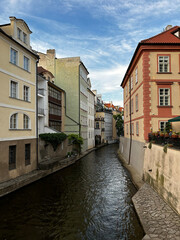 Fototapeta premium Scenic canal between historic buildings in Prague
