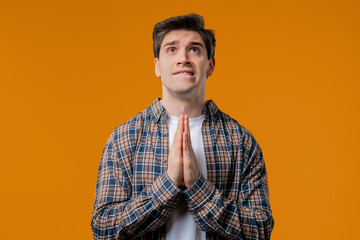 Mature 30s Man Praying, Begs To Apologize, Guilty. Yellow Studio. Hopeful Prayer