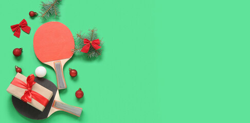 Composition with ping pong rackets, ball and Christmas decorations on color background