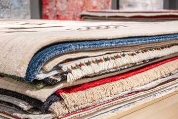 Various west style carpets are arranged in a row in a store, showcasing different textures and...