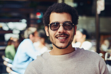 Portrait, man and fashion designer in cafe for creativity, showcase and trendy clothes in coutour. Male person, happiness and outdoor with confidence as artist in restaurant on break or rest in Italy
