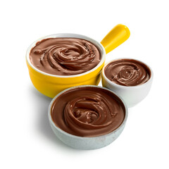 Bowls of tasty melted chocolate on white background