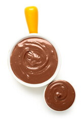 Bowls of tasty melted chocolate on white background