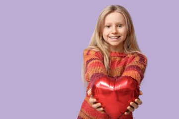 Cute little girl with heart shaped air balloon on lilac background. Valentine's day celebration