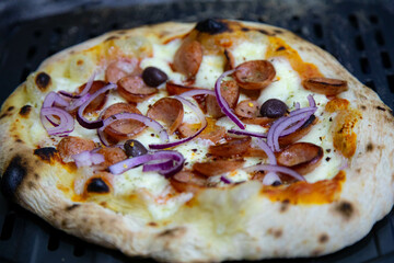 Rustic artisanal pepperoni pizza with red onion