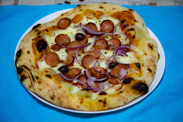 Rustic artisanal pepperoni pizza with red onion