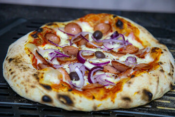 Rustic artisanal pepperoni pizza with red onion
