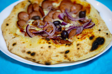 Rustic artisanal pepperoni pizza with red onion