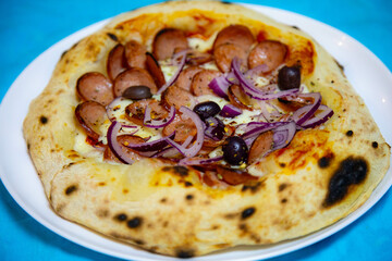 Rustic artisanal pepperoni pizza with red onion