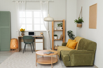 Interior of living room with workplace, sofa and shelf unit