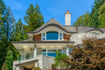 A perfect neighborhood. Houses in suburb at Fall in the north America. Top of a luxury house with nice window over blue sky.