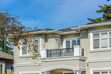 A perfect neighborhood. Houses in suburb at Fall in the north America. Top of a luxury house with nice window over blue sky.