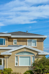 A perfect neighborhood. Houses in suburb at Fall in the north America. Top of a luxury house with nice window over blue sky.