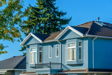 A perfect neighborhood. Houses in suburb at Fall in the north America. Top of a luxury house with...