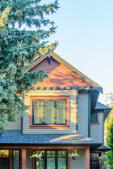A perfect neighborhood. Houses in suburb at Fall in the north America. Top of a luxury house with nice window over blue sky.