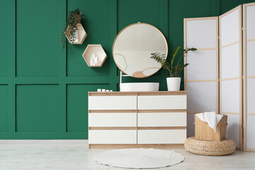 Interior of bathroom with sink, mirror and folding screen