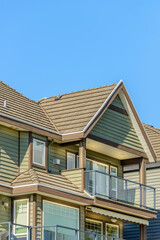 A perfect neighborhood. Houses in suburb at Fall in the north America. Top of a luxury house with nice window over blue sky.