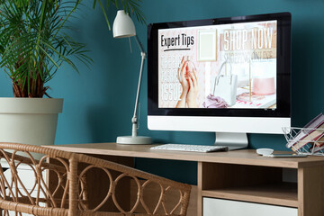 Computer monitor with open site of online store on desk in office