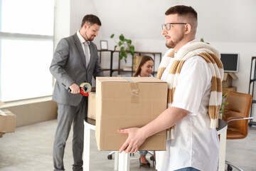 Businessman carrying box in office on moving day