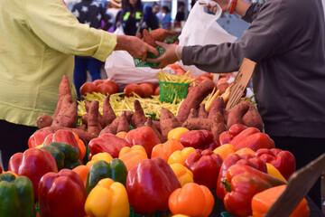 Person buying fresh produce at farmers market
