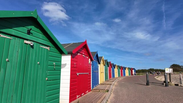 Dawlish Warren Devon England. 01.10.2024. Video. Row of colourful beach huts to hire on the Dawlish Warren seafront in Devon England UK
