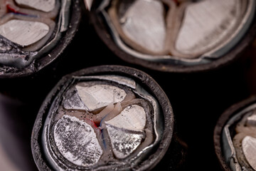 Several cut ends of armored power cables with aluminum conductors are displayed, highlighting their intricate design and structure.