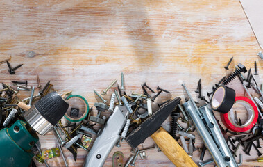 Different hand tools and fasteners on wooden surface. Home repair concept. Copyspace