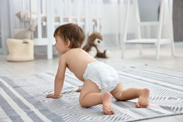 Cute little child in diaper at home