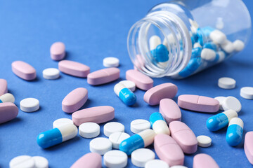 Pharmacist concept. Many different pills on blue background, closeup