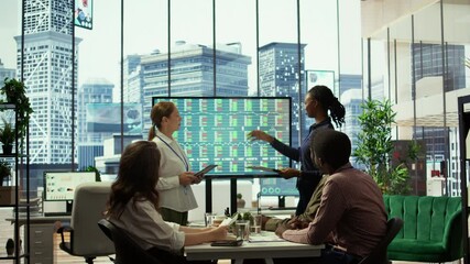 Management team holding a strategy session with the staff, focusing on digital marketing trends, budget allocation and progress tracking to achieve goals and boost market presence. Camera B.