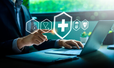 Businessman Using Laptop and Touching Virtual Health Insurance Icon with Medical Symbols for Healthcare, Protection, Digital Health Solutions, Representing Medical Services, Wellness, Coverage