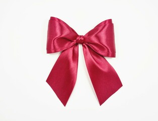 Beautiful bow made of burgundy satin ribbon on a white background