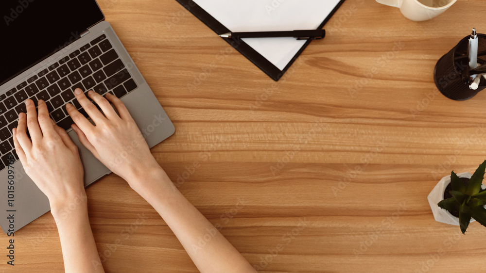Poster education. top view female hands typing on a laptop keyboard with isolated screen on wood desk with 