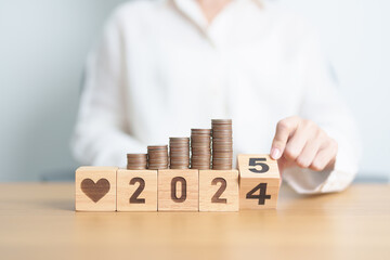 2024 end year to Happy New Year 2025 with Doctor, heart shape and coins stack. Money for Healthcare cost, Money Saving, Health Insurance, Medical, Donation and Financial concept