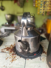 aluminum teapot filled with boiling tea water