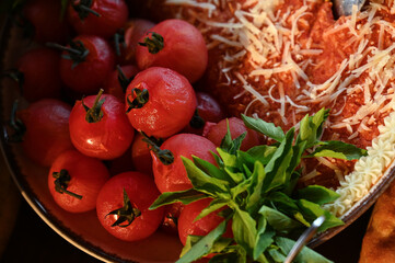fresh vegetables on the buffet,skinless tomatoes, basil leaves, fresh basil