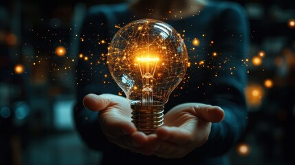 Hand holding light bulb in front of global