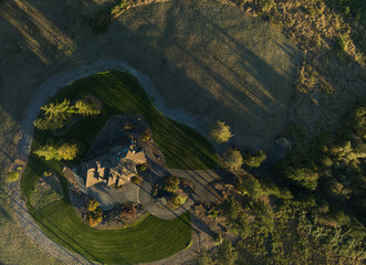 A house with a large yard and a pond