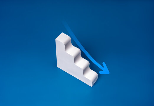 Down arrow on white geometric stairway, decrease business graph down step, finance diagram on blue background. Financial crisis, bankruptcy, loss investment economic recession sales risk concepts.