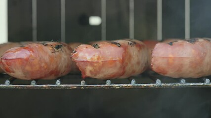 Smoking sausages outside 