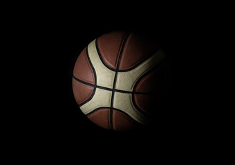 Basketball ball in minimalist style isolated on black background. Basketball ball leather texture with bumps pattern background, Light and Shadow, Copy space, Selective focus.